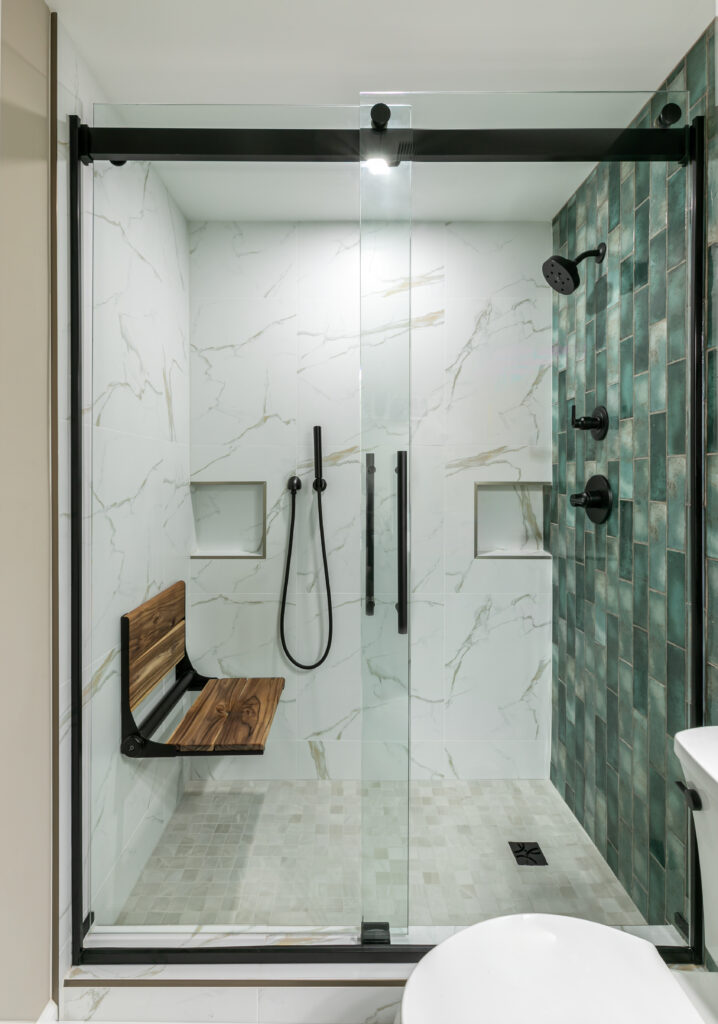 Walk-in shower with marble-look porcelain walls and matte black plumbing fixtures
