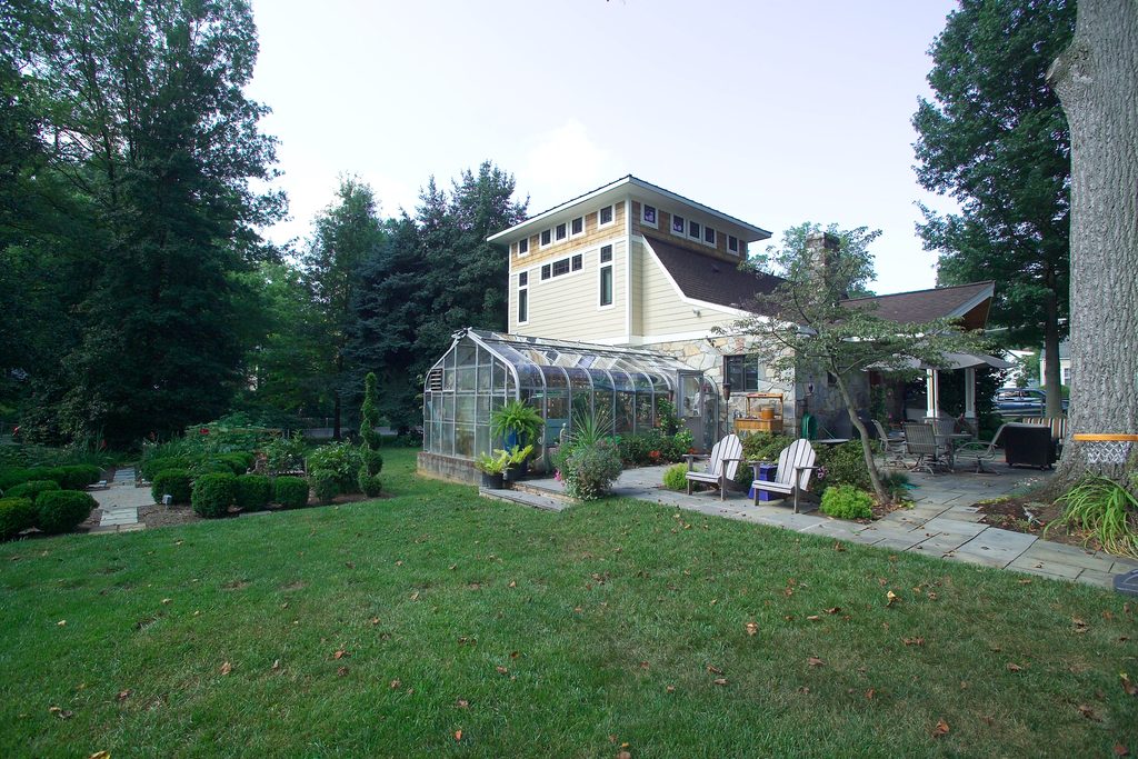 Second-story studio addition with wraparound clerestory windows and a metal roof accent