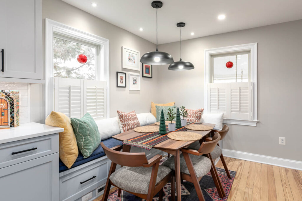 Light and airy kitchen remodel in Leesburg, VA with two-tone flat-panel cabinetry, Lunada Bay Shinju backsplash, and refinished original hardwood floors