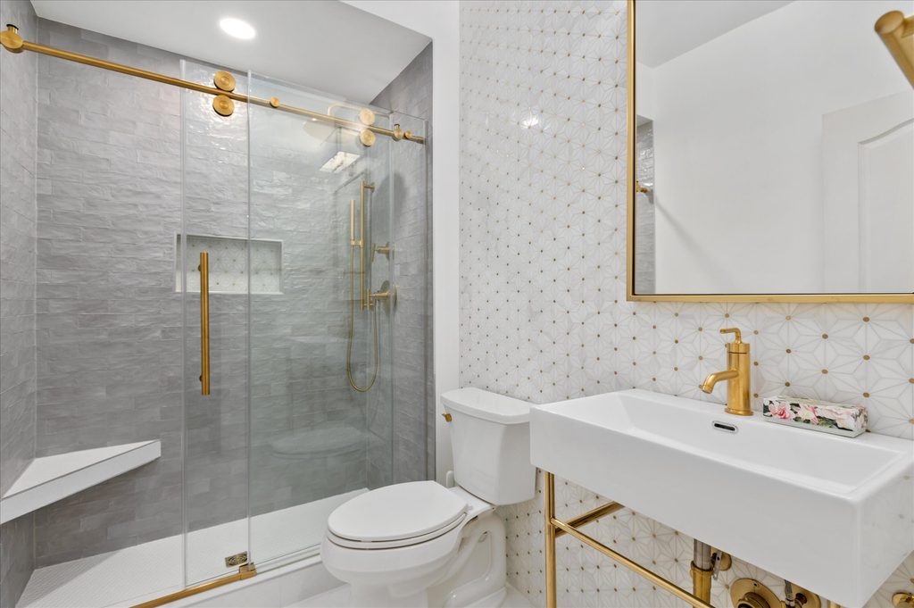 Tub and shower with kelly green wall tile and matte black fixtures