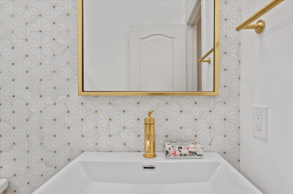 Brushed gold toilet flush lever and matching champagne bronze towel bar