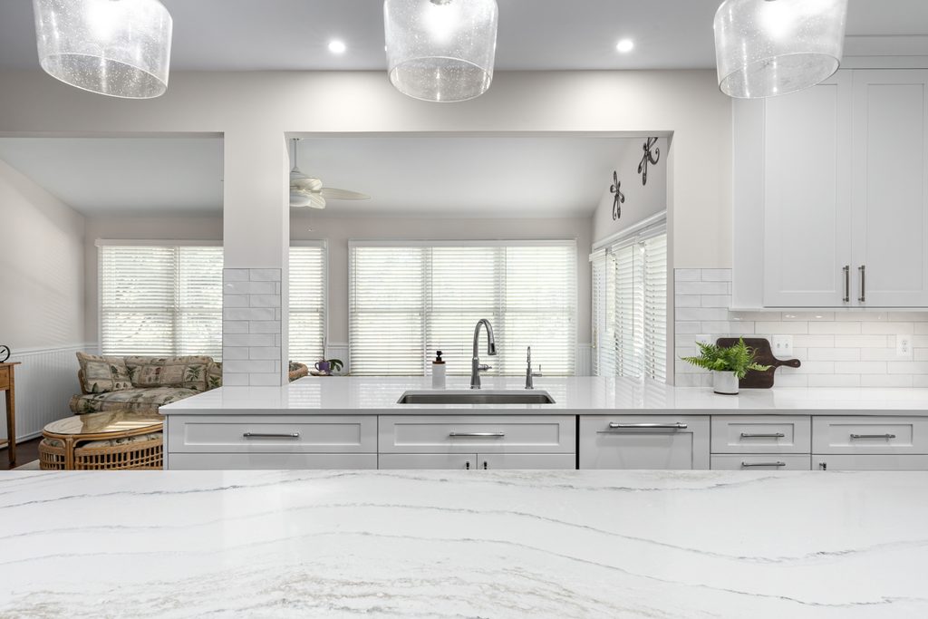 Walk-in pantry with white shelving tucked under an angled staircase