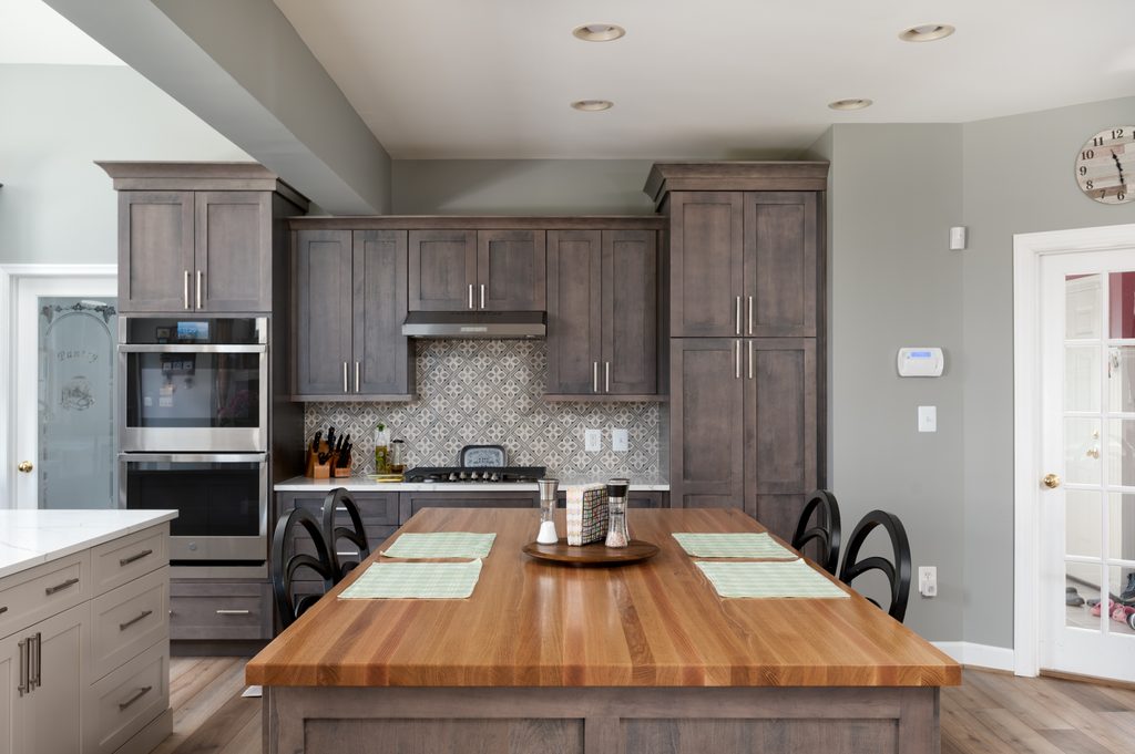 Stained maple eat-on island with a butcher-block top and seating for four