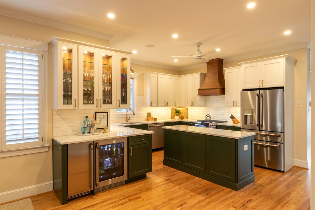 Glass-front upper cabinets with interior lighting displaying stemware